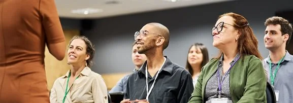 People sitting and listening to an engaging training session.