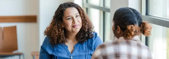A teenage girl getting support from a mental health worker. 