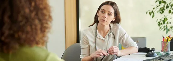 A patient in an appointment with their general practitioner (doctor).