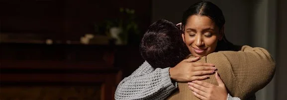 Two people hugging o show support for one another. 