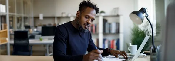 A man studying online from home.