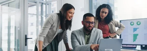 people looking at research in an office environment.