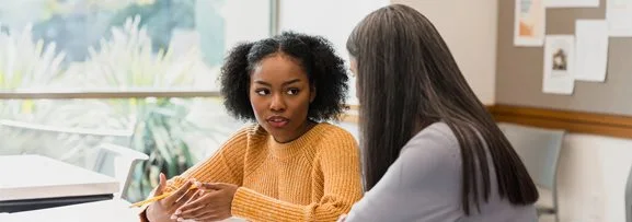 A young women getting support from a mental health worker. 
