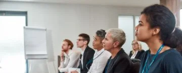 People sitting and listening to a training seminar.