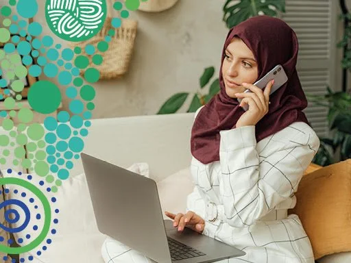 a young women on her phone and laptop.