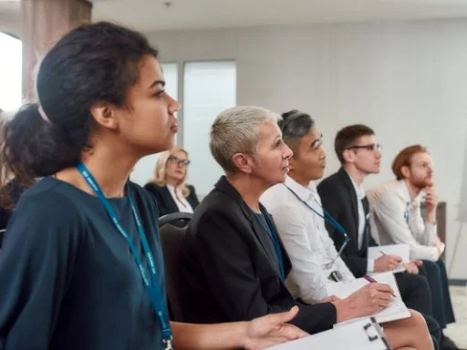 People sitting and listening in a training seminar. 