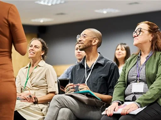 People sitting and listening to an engaging training session.
