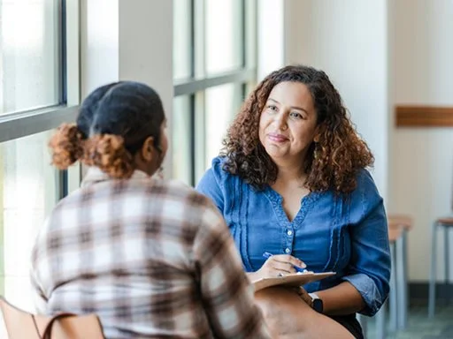 A teenage girl getting support from a mental health worker. 