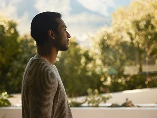 A man standing outside looking into the distance. 