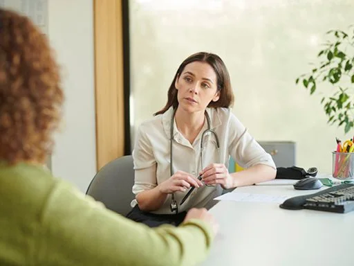A patient in an appointment with their general practitioner (doctor).