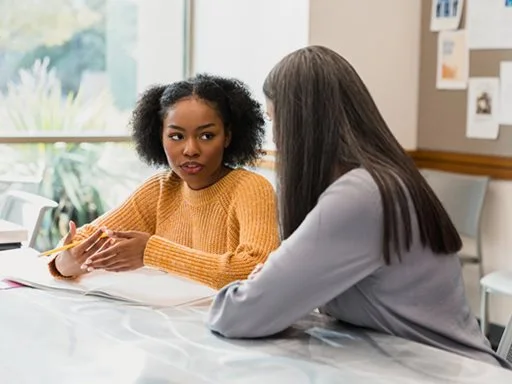 A young women getting support from a mental health worker. 