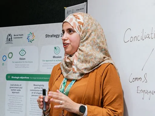 A women confidently speaking in a meeting.