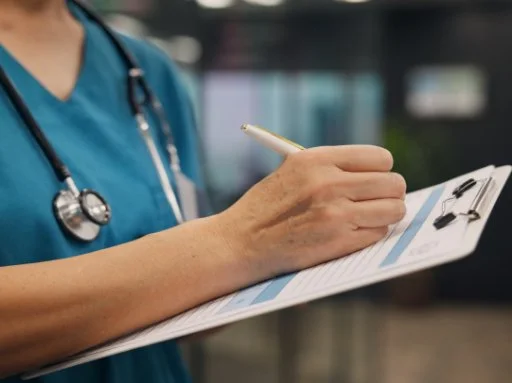 nurse completing survey on a clipboard