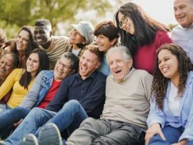 a diverse group of people happily sitting together.