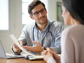 A patient in an appointment with their general practitioner (doctor).